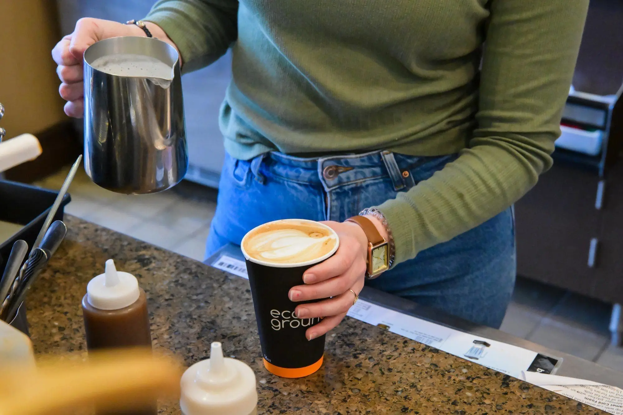 Barista pouring latte